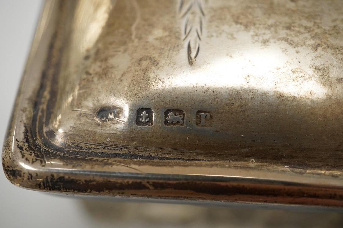 An early 20th century silver mounted cut glass scent bottle, five silver mounted glass toilet jars, a pair of silver mounted dwarf candlesticks, two silver condiments, a sterling jug(weighted), a sterling cup and cover(w